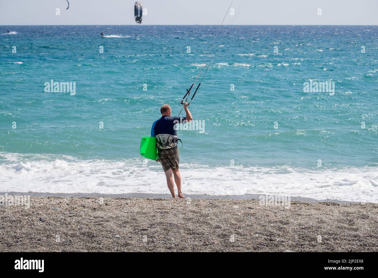 Kitesurfer holding the kite from the control bar Stock Photo