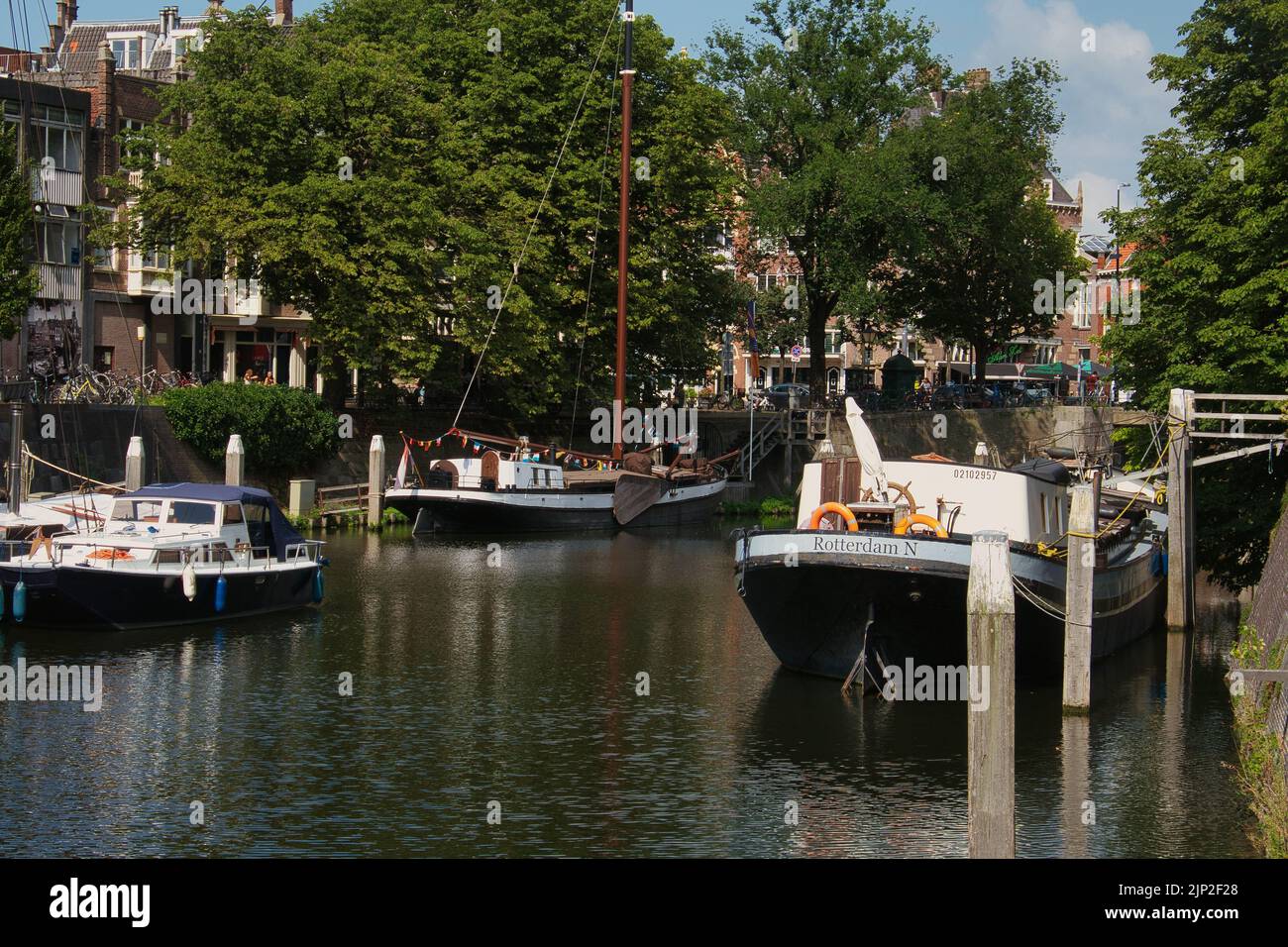 Moored boats on the river in Schiedam, the Netherlands Stock Photo