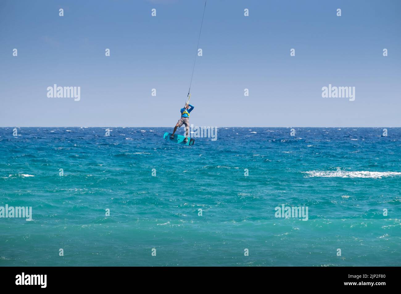 Man kitesurfing and jumping in the Beach of Agiokampos, Greece Stock Photo