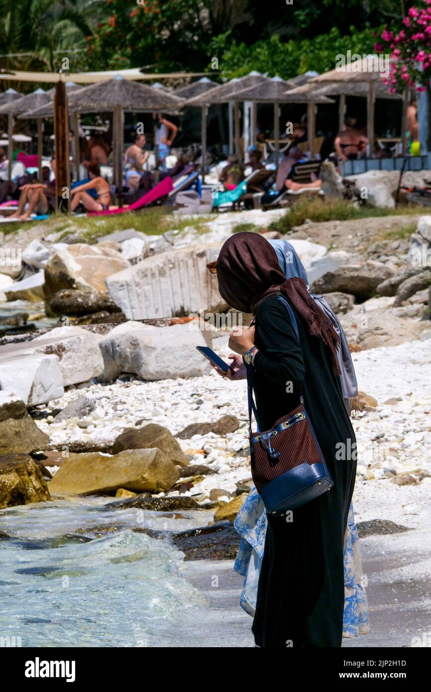 Muslim tourist standing on the seaside, Thassos, Macedonia, North-Eastern France Stock Photo