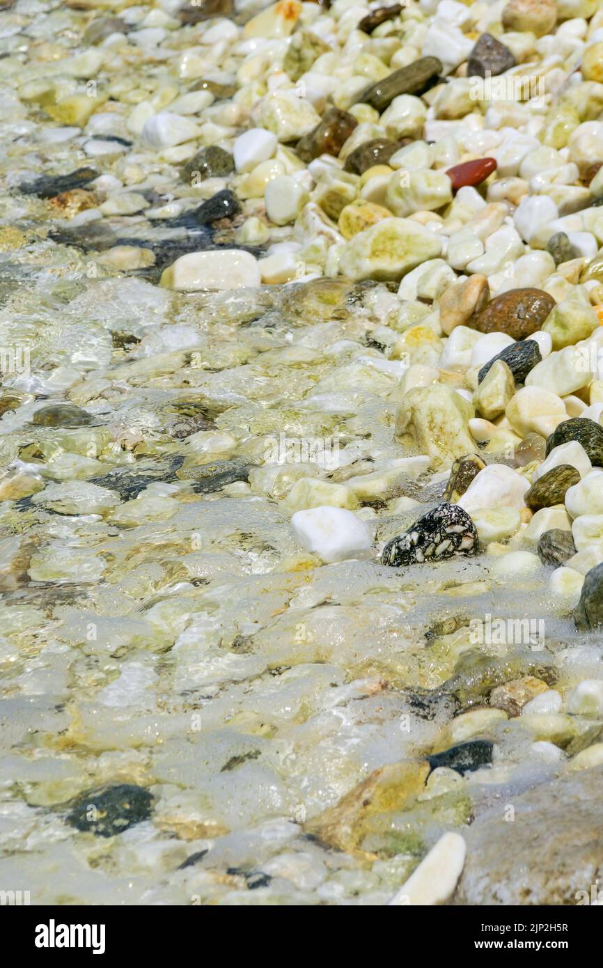 Moving water over marble pebble beach, Thassos, Macedonia, North-Eastern France Stock Photo