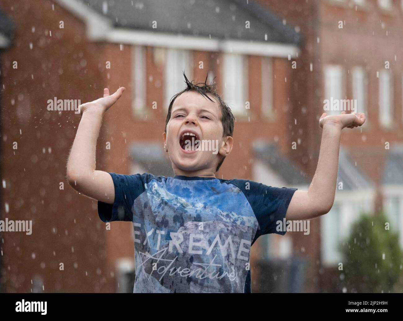 Haverhill, Suffolk, UK 15th August 2022. Albert Mitchell, 5 years old enjoys the torrential rain in Haverhill, Suffolk. Credit: Headlinephoto/Alamy Live News. Stock Photo