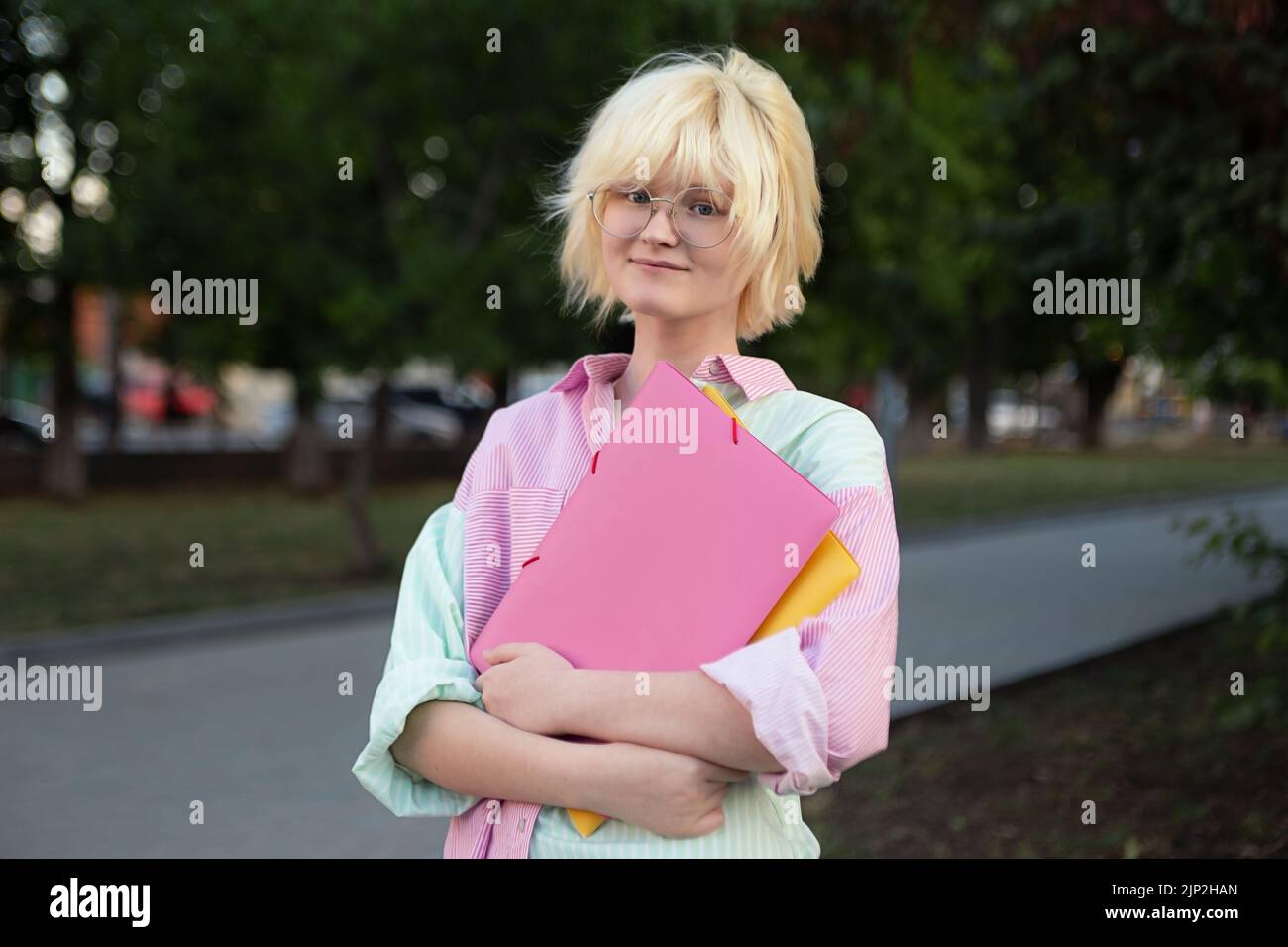 Horizontal photography of teenage girl student staying outside stock