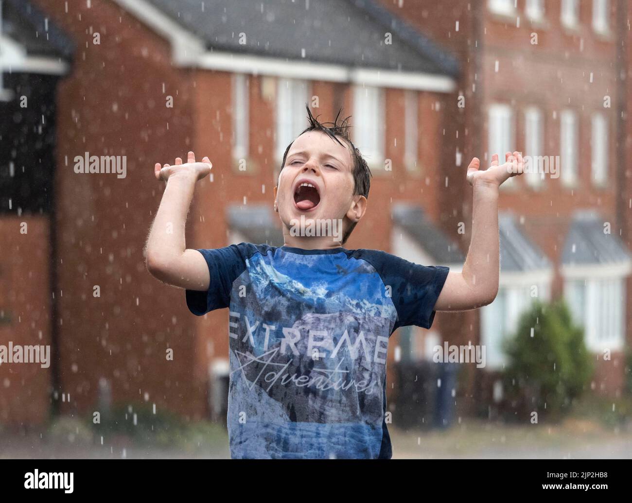 Haverhill, Suffolk, UK 15th August 2022. Albert Mitchell, 5 years old enjoys the torrential rain in Haverhill, Suffolk. Credit: Headlinephoto/Alamy Live News. Stock Photo
