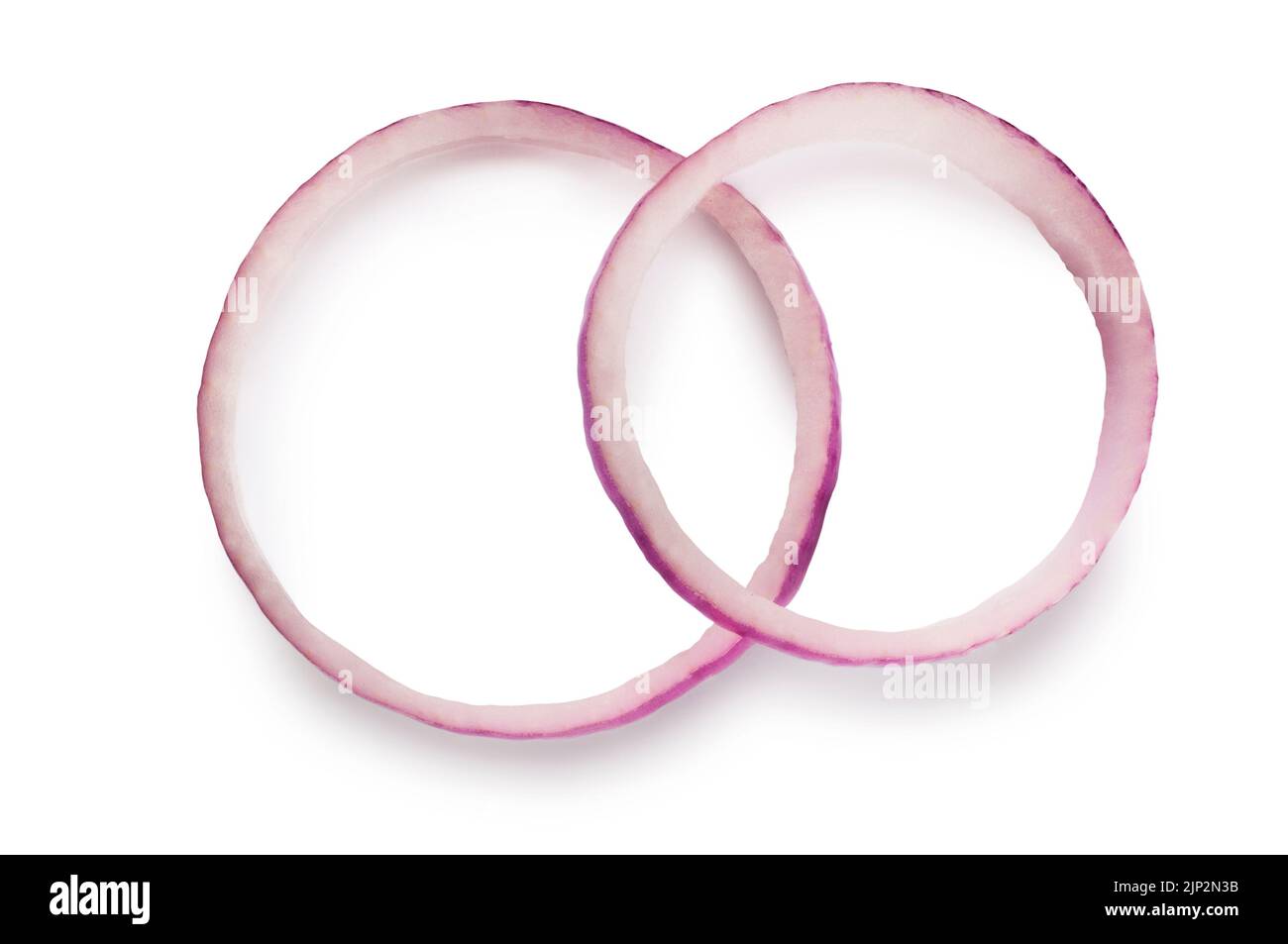 Studio shot of sliced red onions rings cut out against a white background - John Gollop Stock Photo