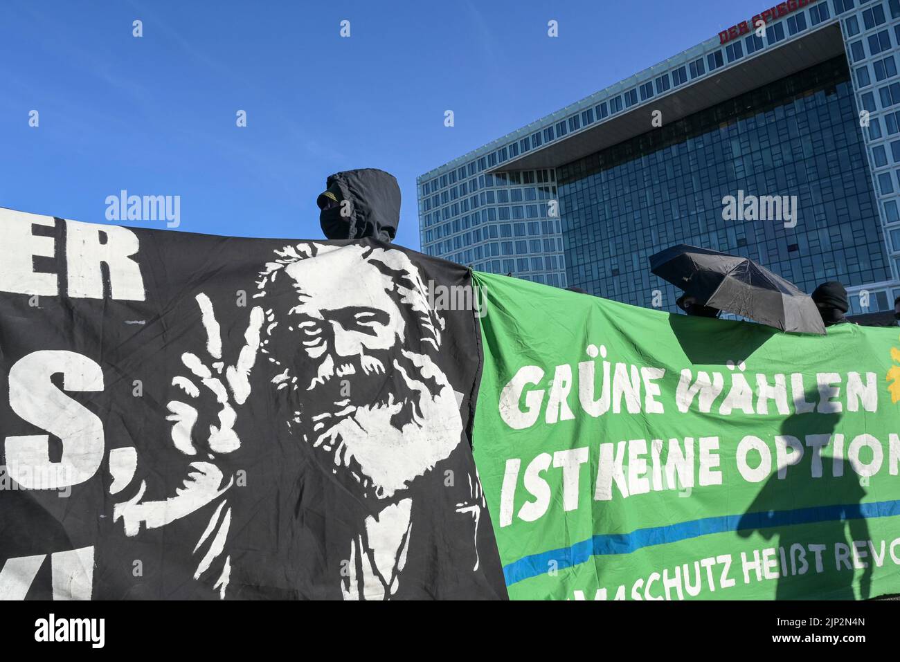 GERMANY, Hamburg city, climatecamp 2022 rally for climate protection and climate justice, black block of antifascist movement Antifa infront of editor building of german news magazine Der Spiegel in Hafencity , banner with Karl Marx ands capitalism critic Stock Photo