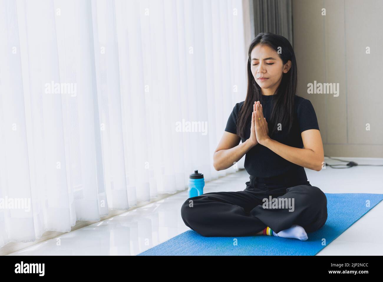 Asian indian woman doing buddha ways meditation yoga for mental health care at home Stock Photo