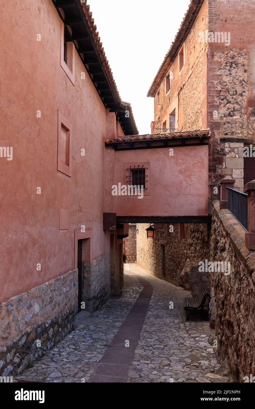 Narrow alley with old stone houses in medieval style in the town of