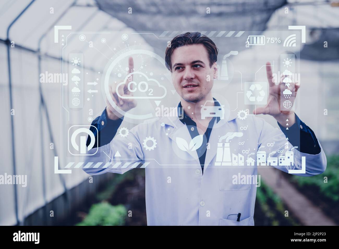 Scientist male researcher looking visual display overlay information data in agriculture farm. Agricultural Science and Technology concept. Stock Photo