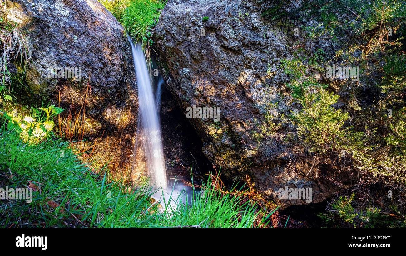 Small Waterfall Between Rocks Small waterfall with rocks in the forest hi-res stock photography and ...