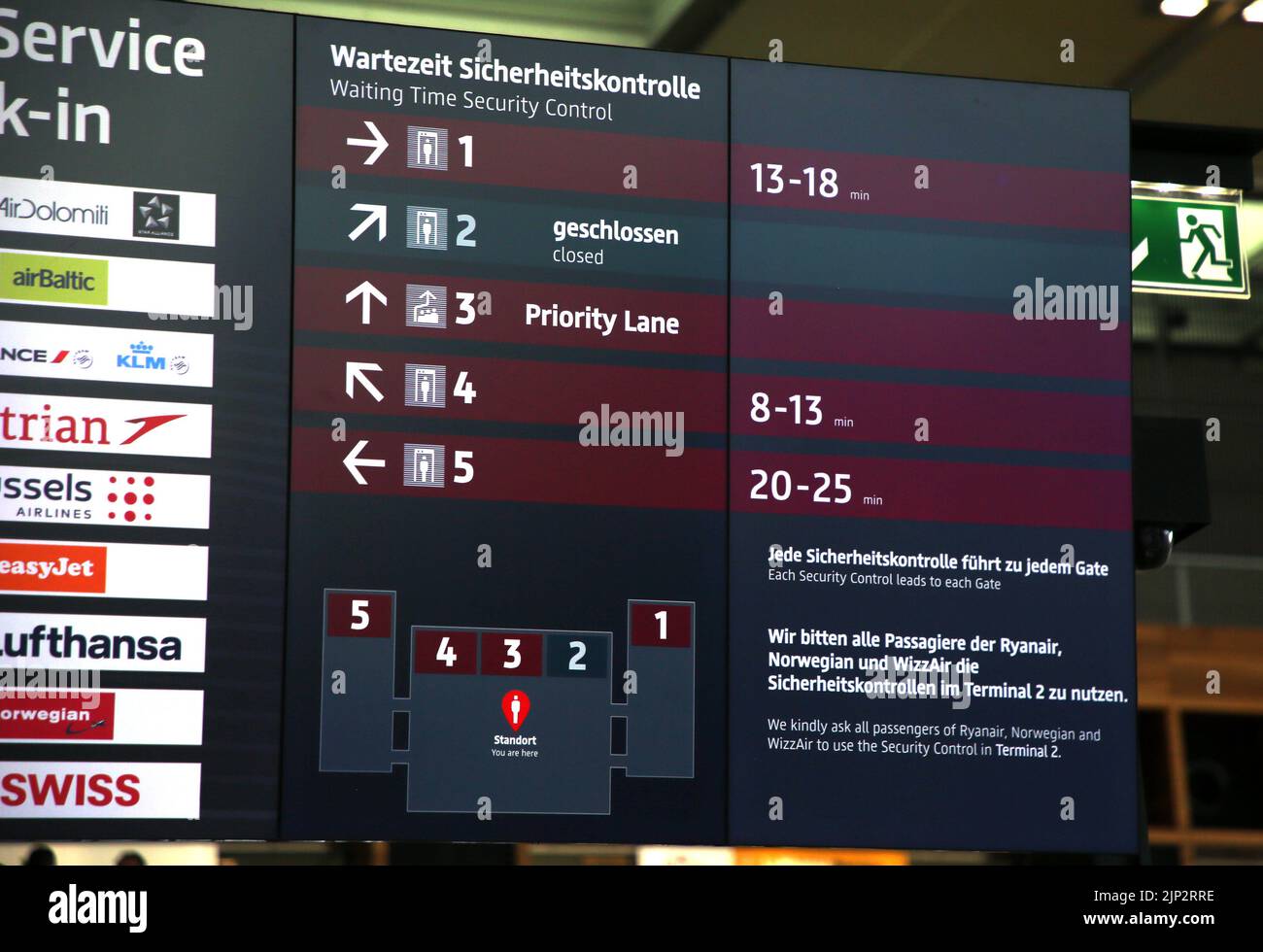 12 August 2022, Brandenburg, Schönefeld: A new type of display board in the main hall of Berlin Brandenburg BER Airport informs passengers about waiting times at various security checkpoints. Photo: Wolfgang Kumm/dpa Stock Photo