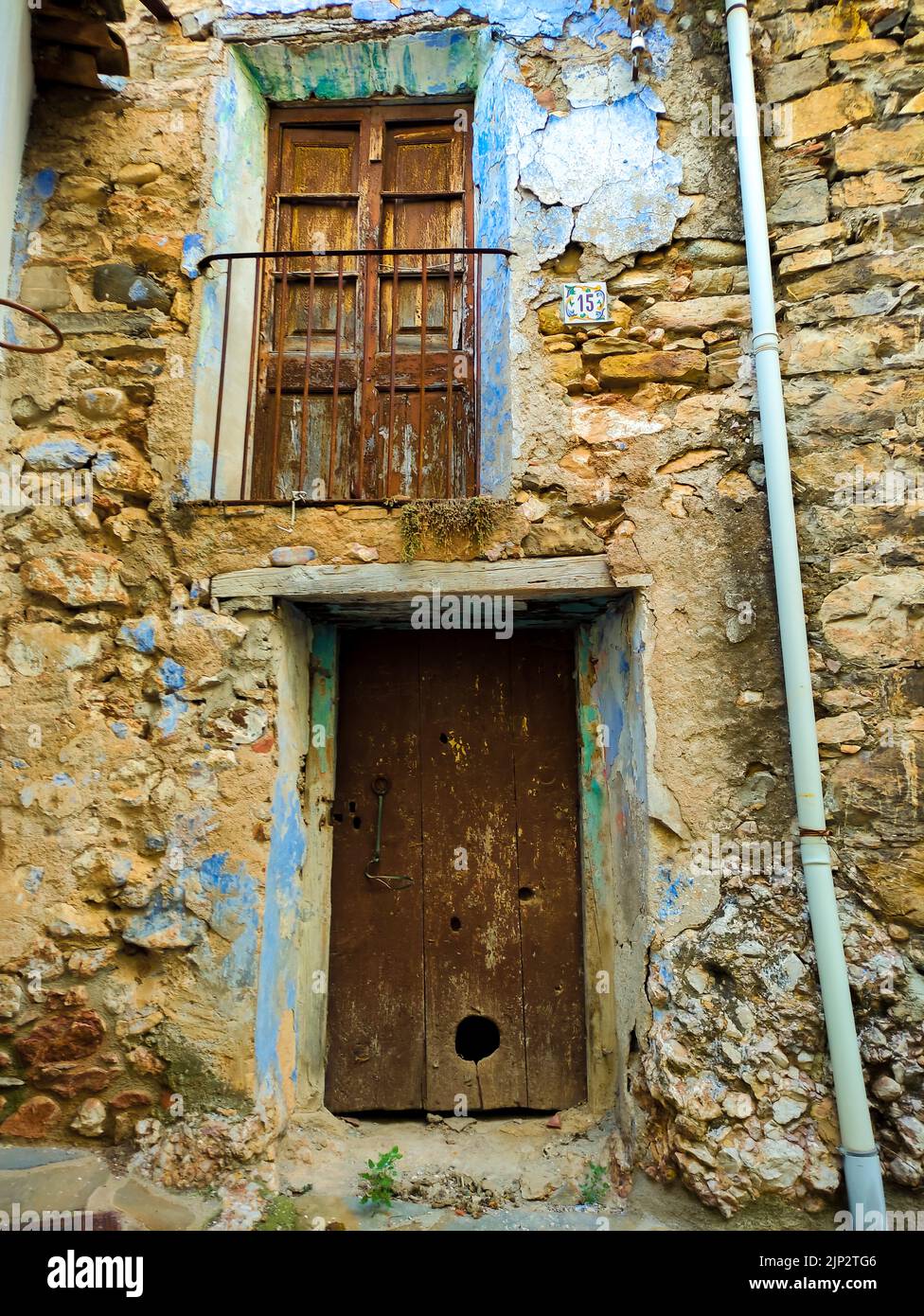 Ancient wood door house with stone wall. Old house in Spain Stock Photo ...