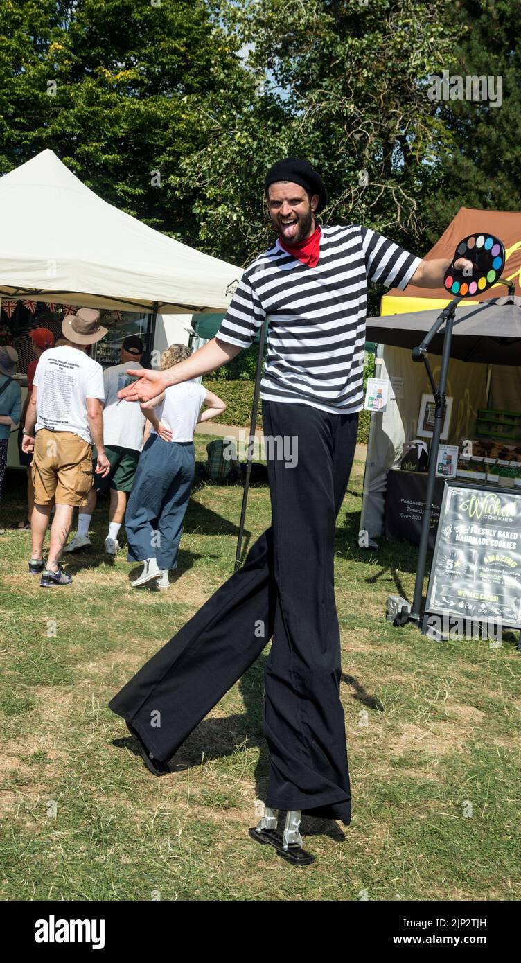 A man on stilts at Art in the Park, Leamington Spa, Warwickshire, UK