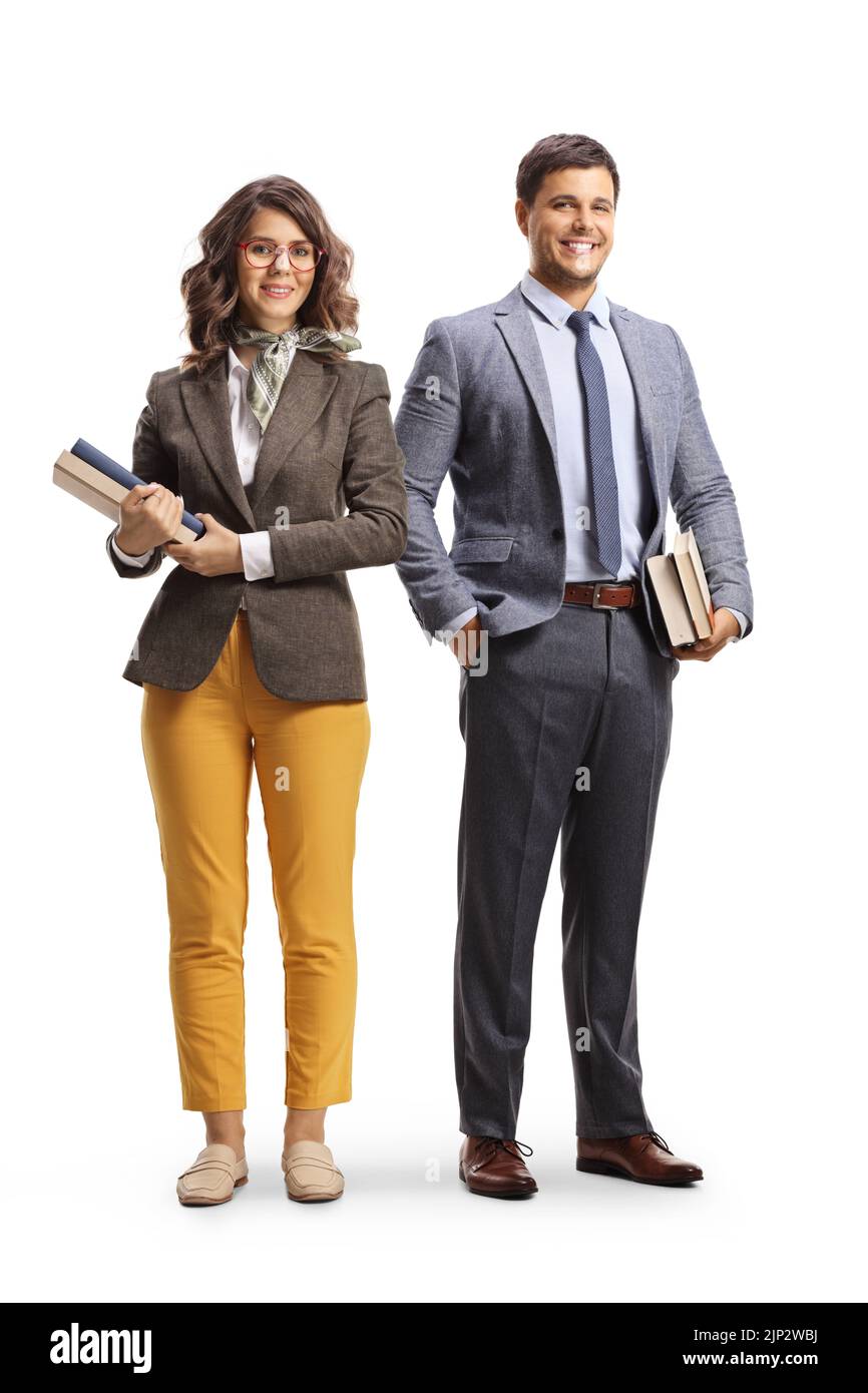 Full length portrait of a male and female teacher standing and holding books isolated on white background Stock Photo