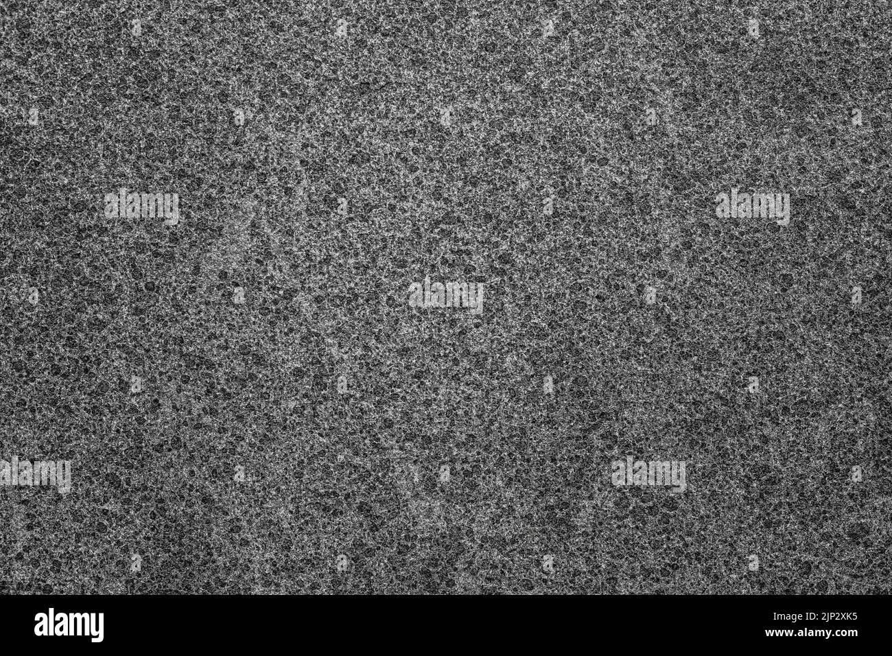 A closeup of black and white structured texture of a grey grungy wall ...