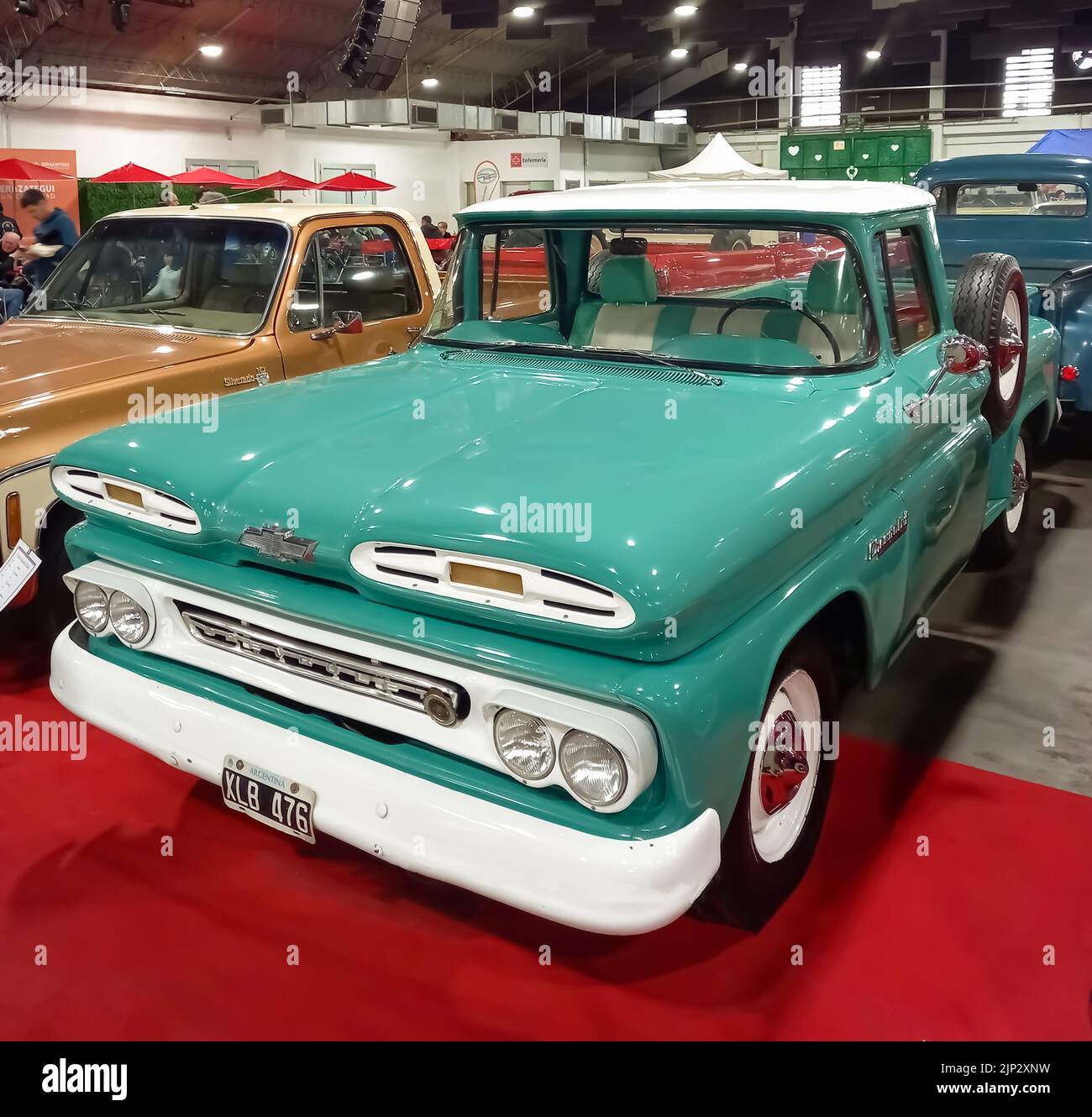 Old aqua and white Chevrolet Chevy C10 Apache pickup truck early 1960s. Utility or farming tool. Exhibit hall. Classic car show. Stock Photo