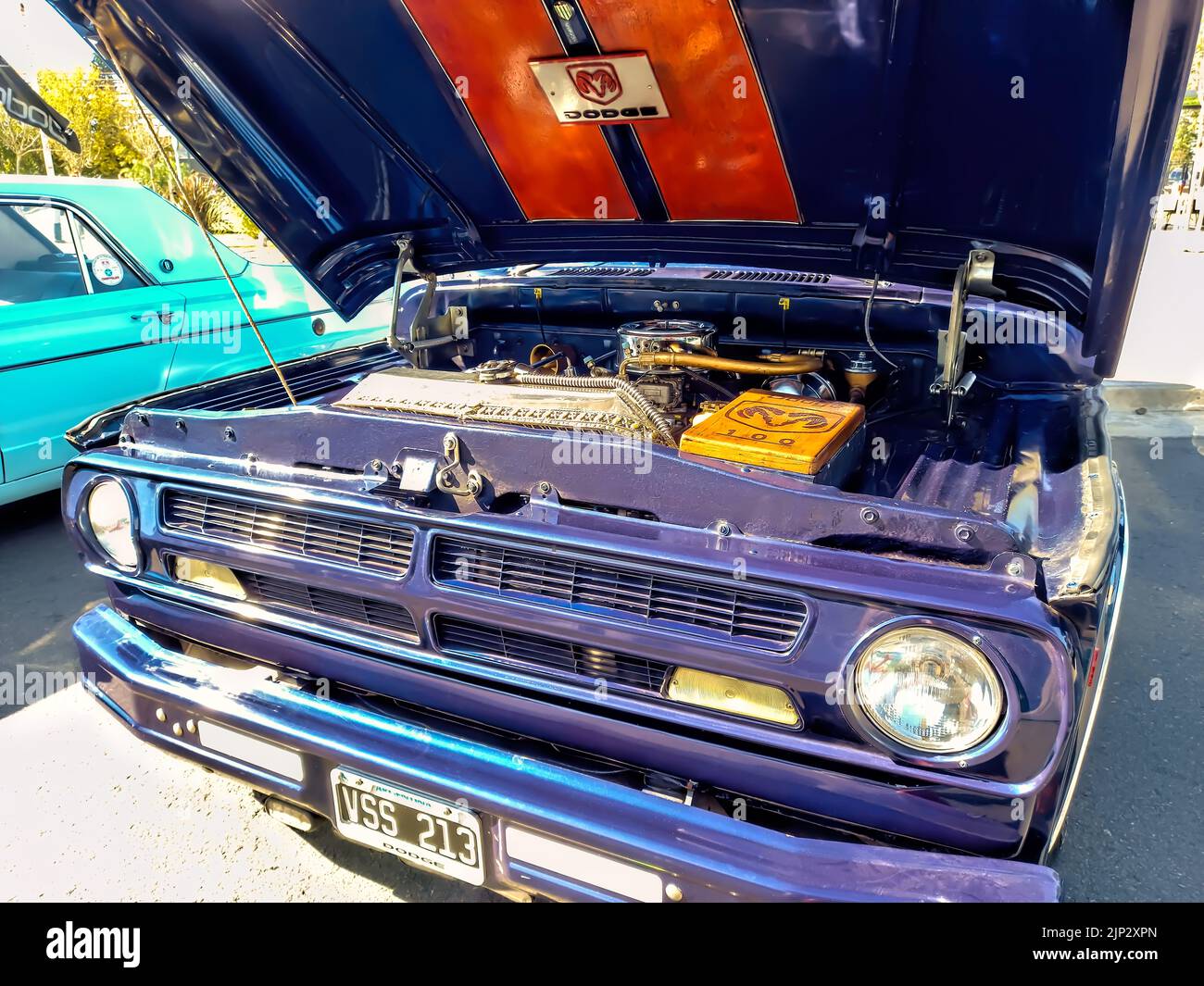 open hood of an old blue pickup truck 1960s Dodge D 100 by Chrysler showing the engine. Utility or farming tool. Expo Fierro 2022 classic car show Stock Photo
