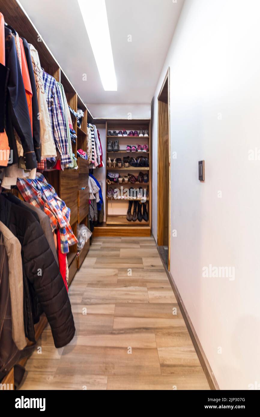facade of a modern house with stone, staple that wraps the windows painted in gray, metal