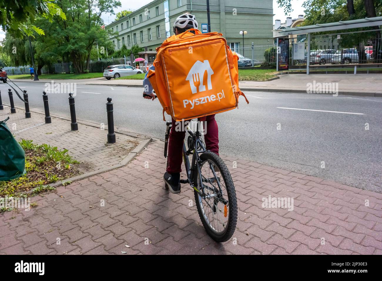 Warsaw, Poland, Street Scene, Food Delivery Man on Bicycle, Old Town Center Stock Photo