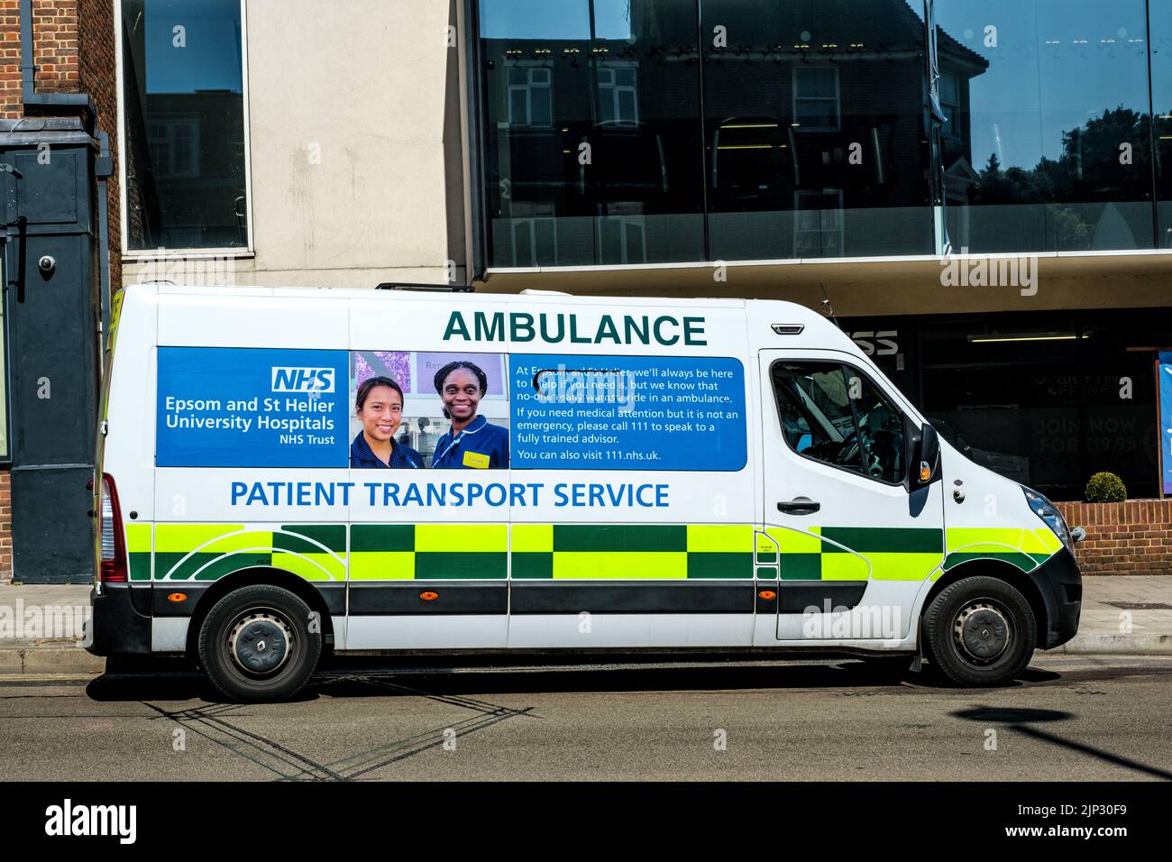 Dorking, Surrey Hills, London UK, August 13 2022, NHS Patient Transport Ambulance Parked On A High Street in A Town Centre Stock Photo