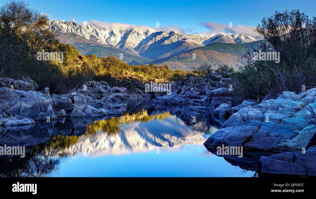 Winter landscape with river, reflections in the water and large rocks. Canencia. Gredos. Stock Photo