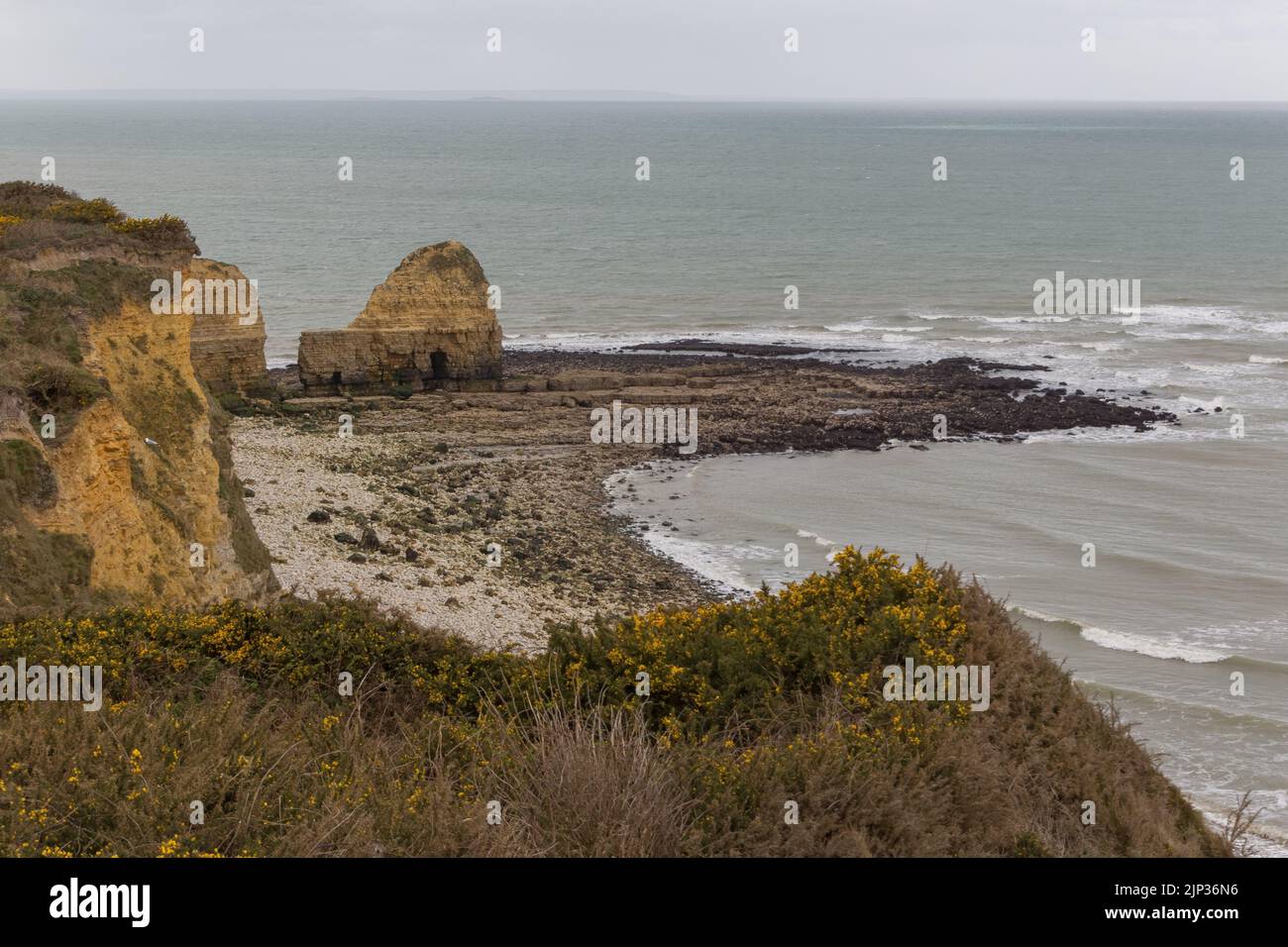 A high angle shot of the promontory of Pointe du Hoc on the rocky coast of a channel Stock Photo