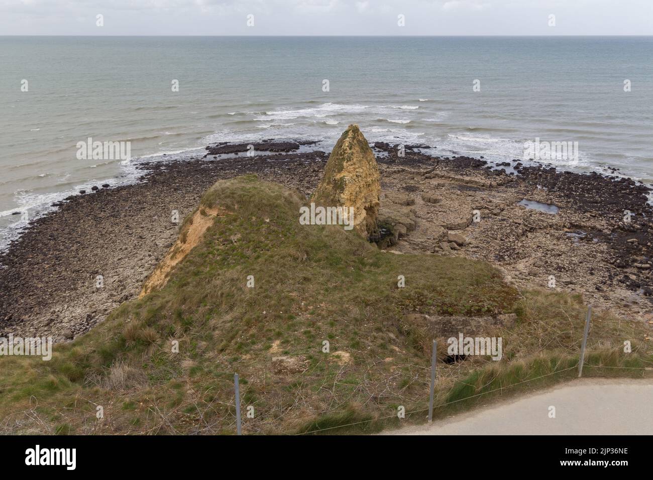 A high angle shot of the Pointe du Hoc on the rocky coast of a channel Stock Photo