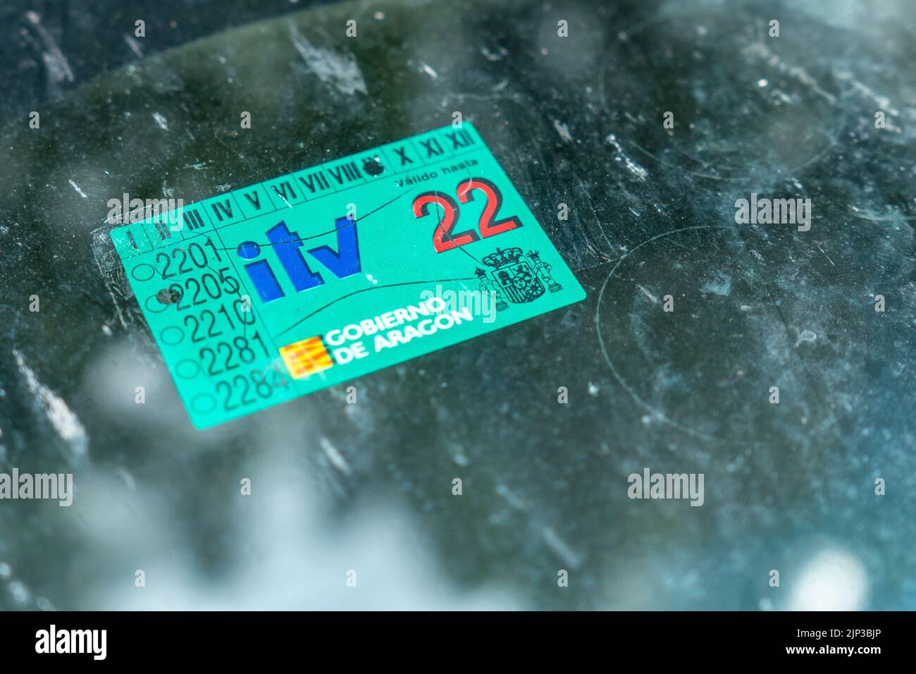 A closeup shot of a vehicle technical inspection sticker in a blue color on a car window Stock Photo