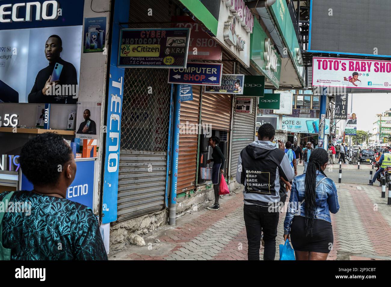 Nakuru, Kenya. 15th Aug, 2022. People walk past closed shops in Nakuru Town ahead of the announcement of the presidential results of the just concluded Kenya's General Election. Kenyans are waiting for the presidential outcome of the general election. Credit: SOPA Images Limited/Alamy Live News Stock Photo