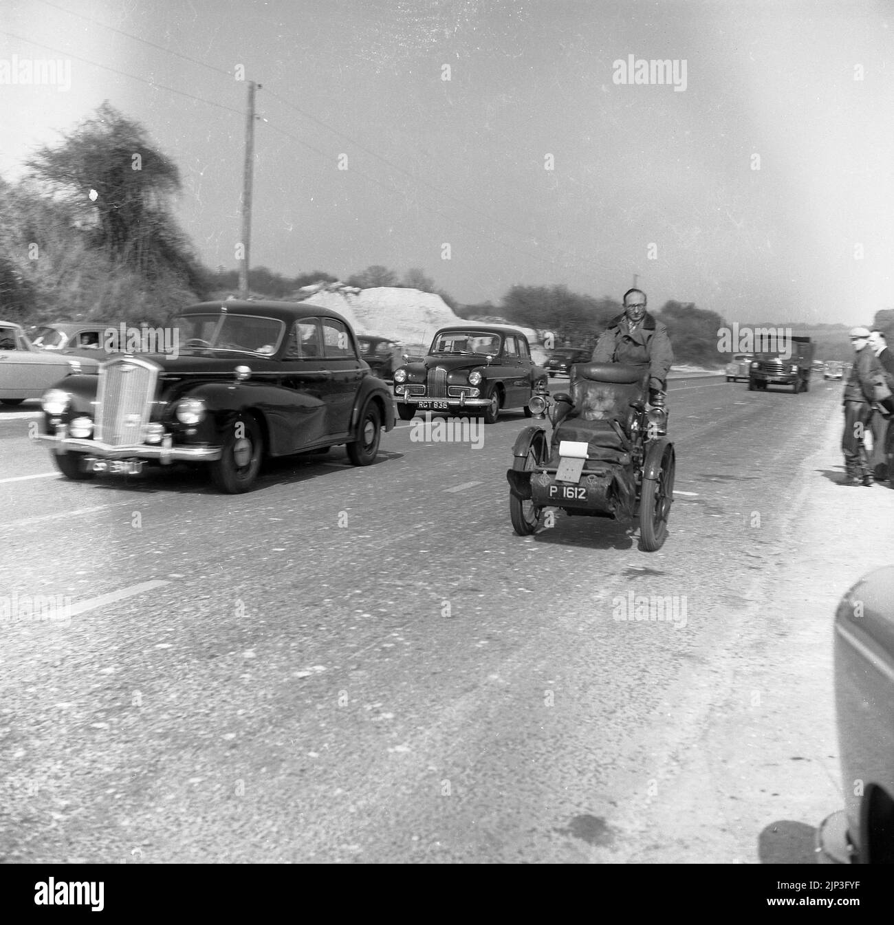 1960, historical, veteran car run, London to Brighton, out on the A23 going towards Brighton, a vintage motor tricycle ( numberplate P 162) three-wheel pre-1905 vehicle, with front seat. Stock Photo