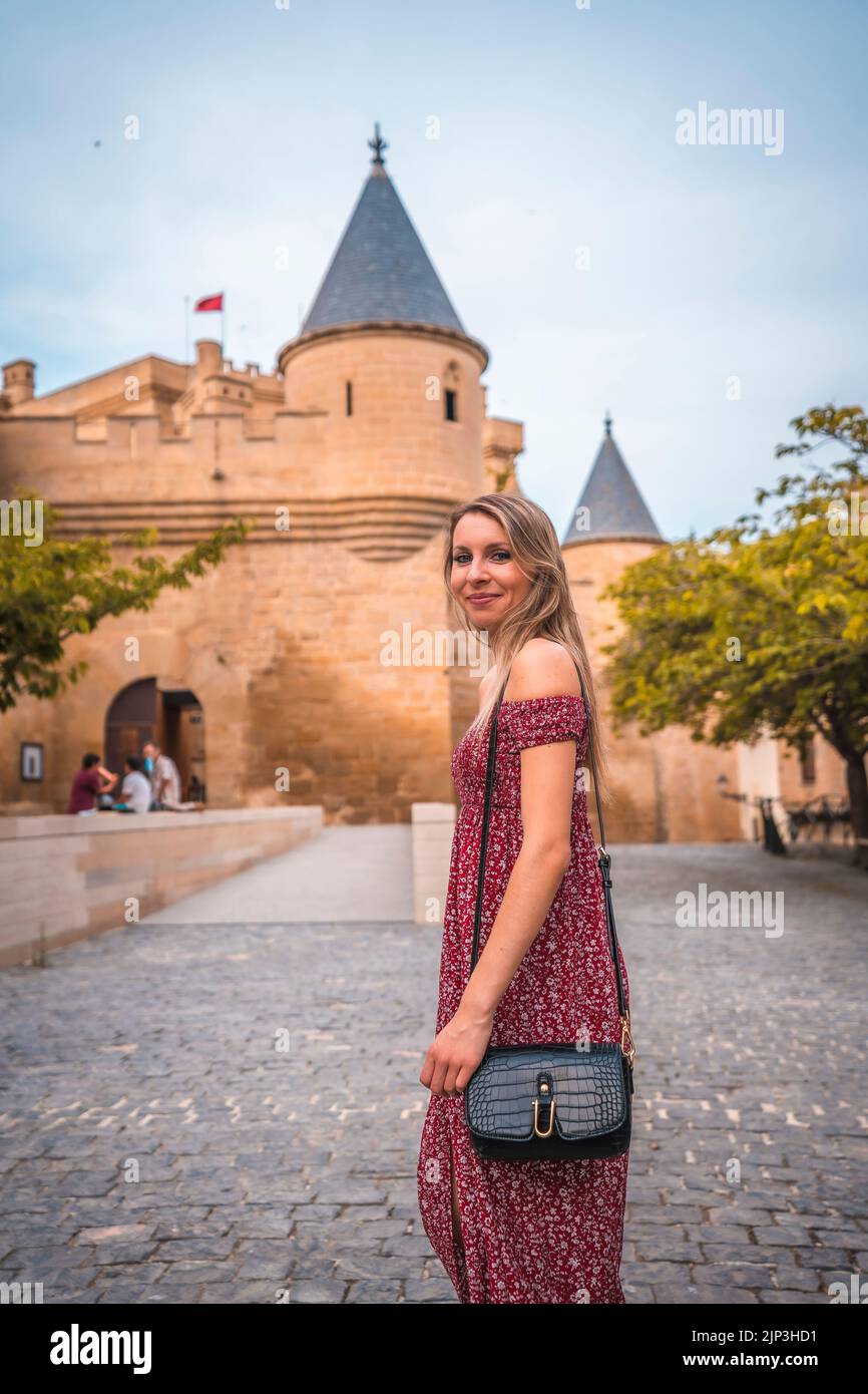 A Blonde Caucasian Girl Wearing A Red Dress Walking In Front Of A Medieval Castle Vertical A Blonde Caucasian Girl Wearing A Red Dress Walking In Front Of A Medieval Castle Vertical