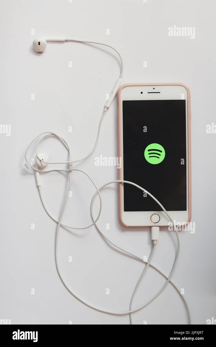 An iPhone with the Spotify logo showing on the screen Stock Photo