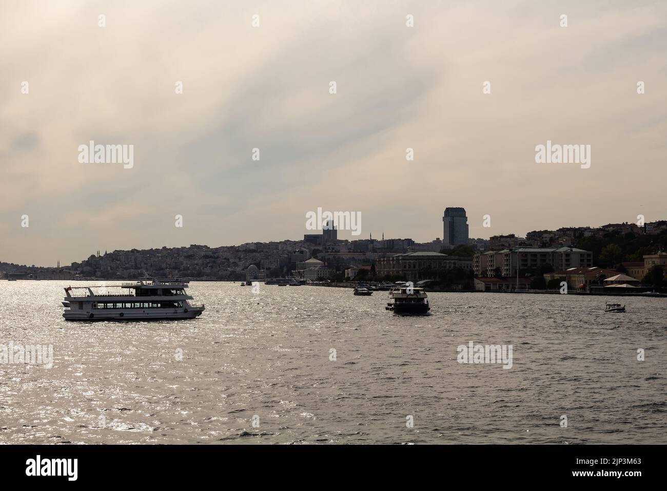 View of cruise tour boats on Bosphorus and European side of Istanbul. It is a sunny summer day. Beautiful scene. Stock Photo