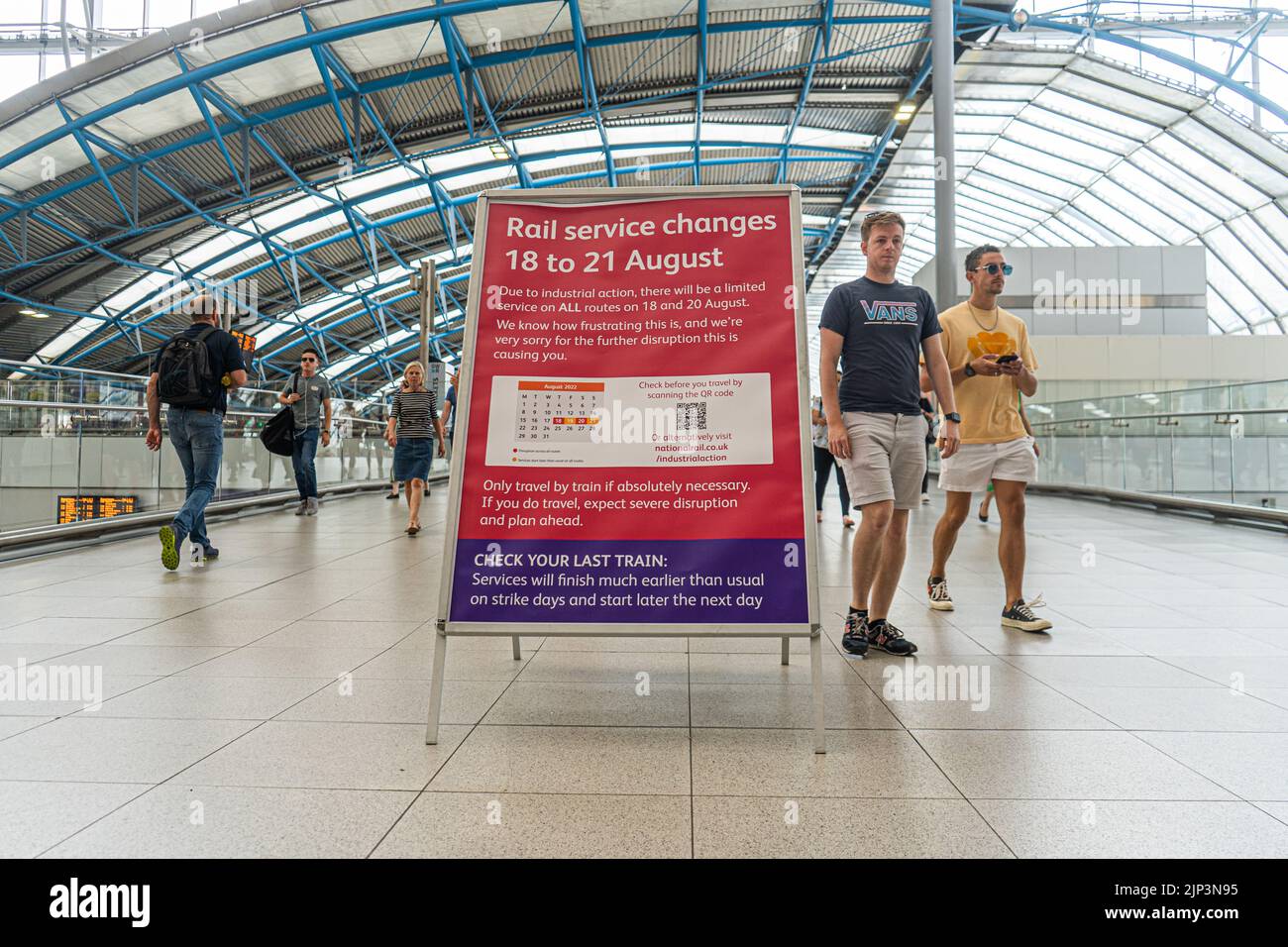 Waterloo London, UK. 15 August 2022 . A sign announcing strike action at a busy Waterloo station with commuters on Monday morning. The Rail, Maritime and Transport Workers (RMT) union has announced strike action from Thursday 18- 21 August  in a walkout by train drivers over a dispute demanding an increase in pay in line with the current inflation of 15 per cent  Passengers have been advised not to travel due to the  severe disruption  on those days Credit. amer ghazzal/Alamy Live News Stock Photo