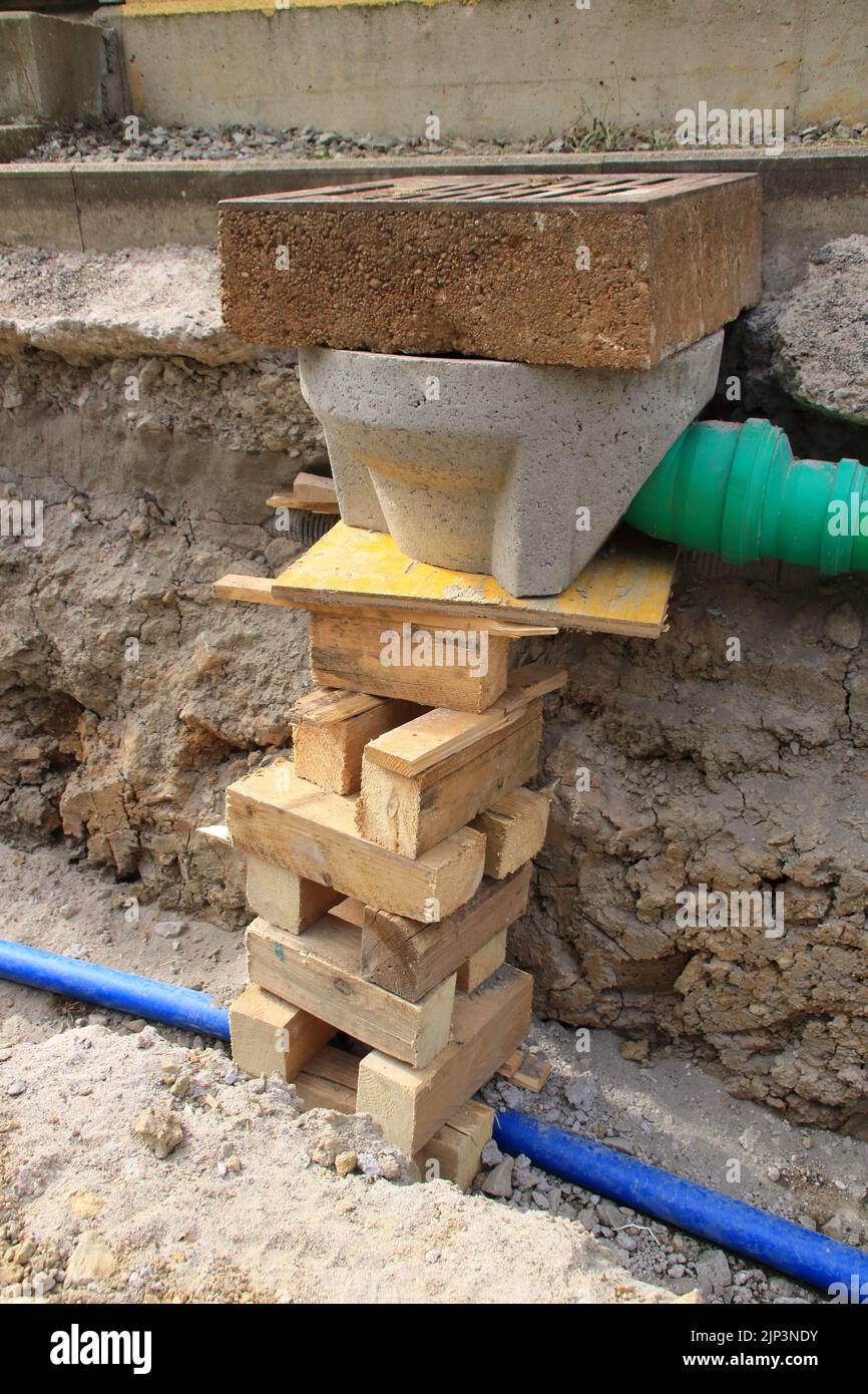 Rainwater well is prepared for installation in the street Stock Photo