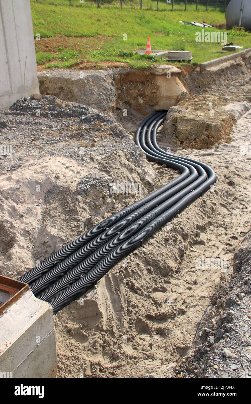 Empty conduits for cables lie in a trench Stock Photo Alamy