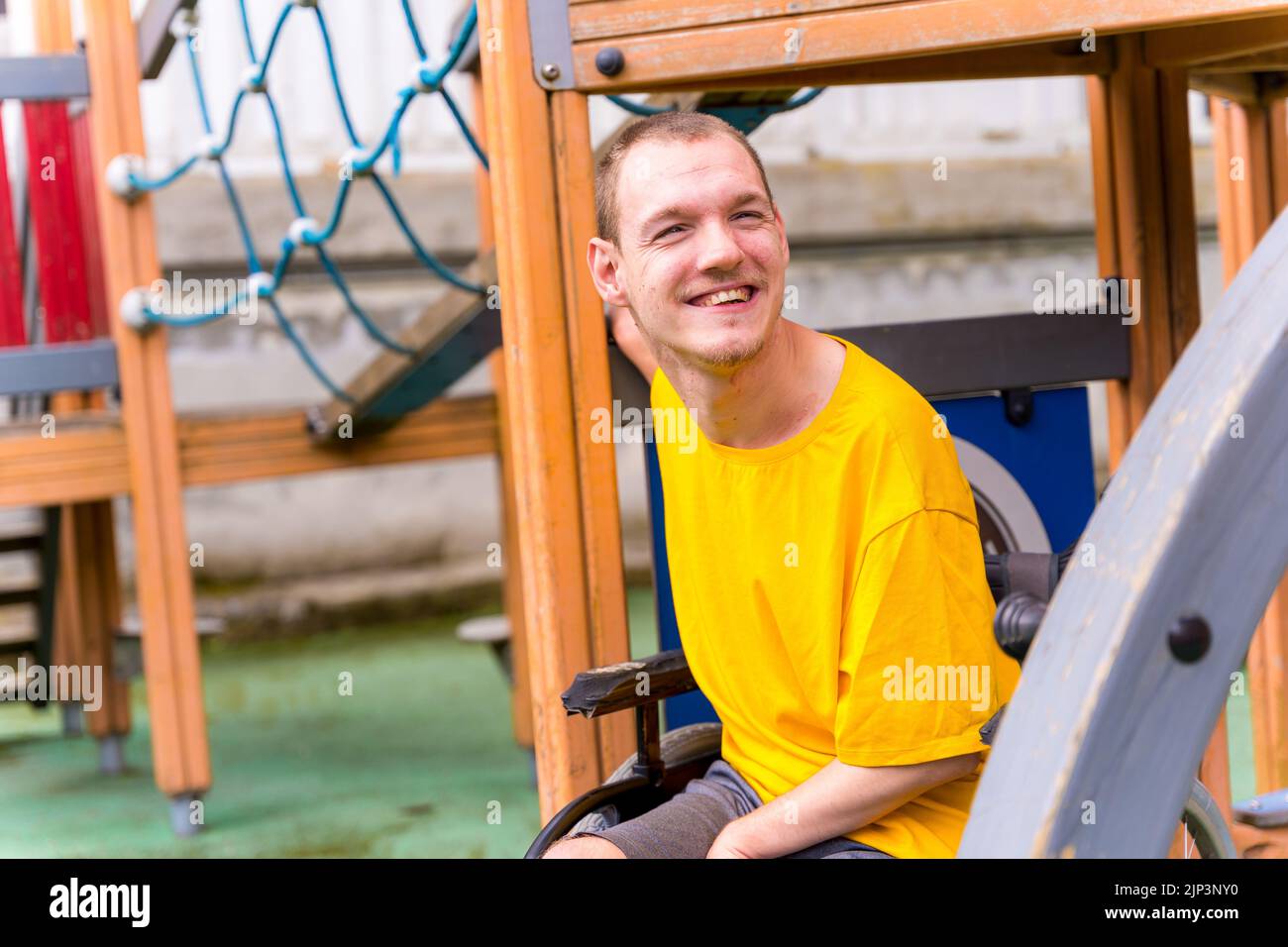 A Disabled Person In A Wheelchair On The Swings Of A Playground Stock A Disabled Person In A Wheelchair On The Swings Of A Playground Stock