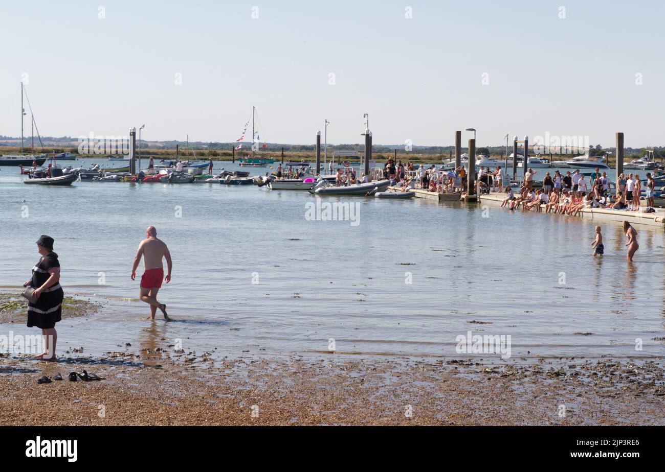 West Mersea Town Regatta on Mersea Island in Essex. The pontoon is crowded with people on a hot summers day enjoying the annual regatta. Stock Photo