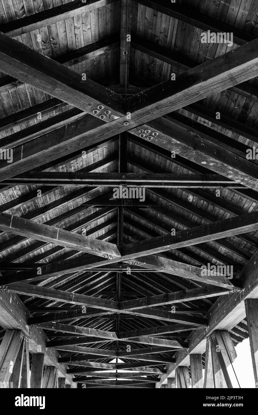 A vertical grayscale shot of a long wooden roof from inside Stock Photo ...