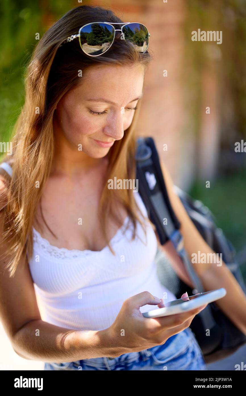 Woman using her mobile phone Stock Photo