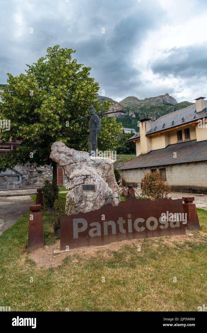 A vertical shot of the skier sculpture in the village of Panticosa under a cloudy sky Stock Photo