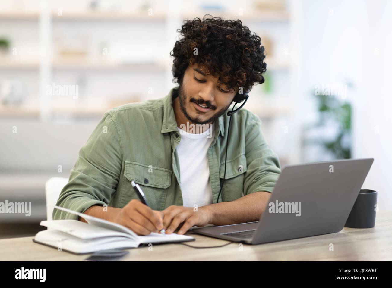 Young indian man having online training, home interior Stock Photo