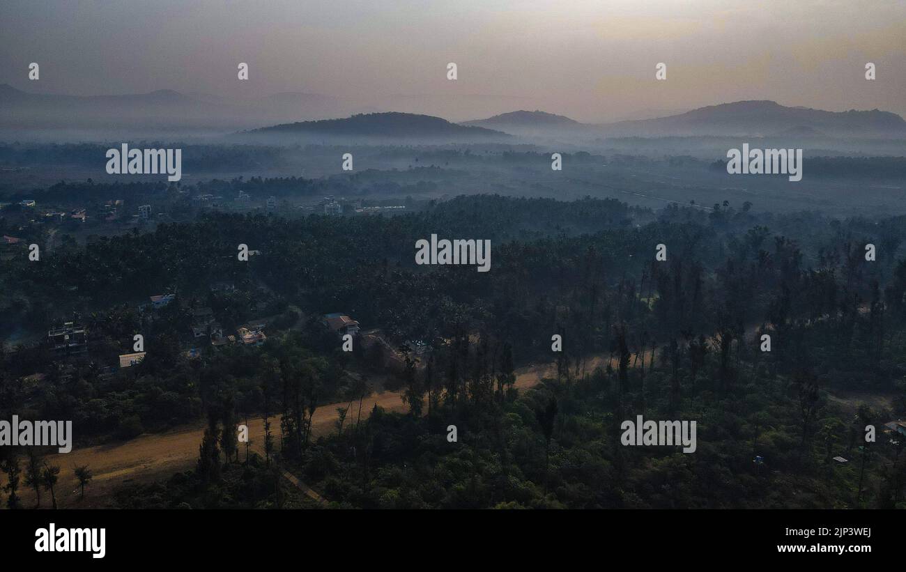 An aerial view of misty green forest with mountains Stock Photo - Alamy