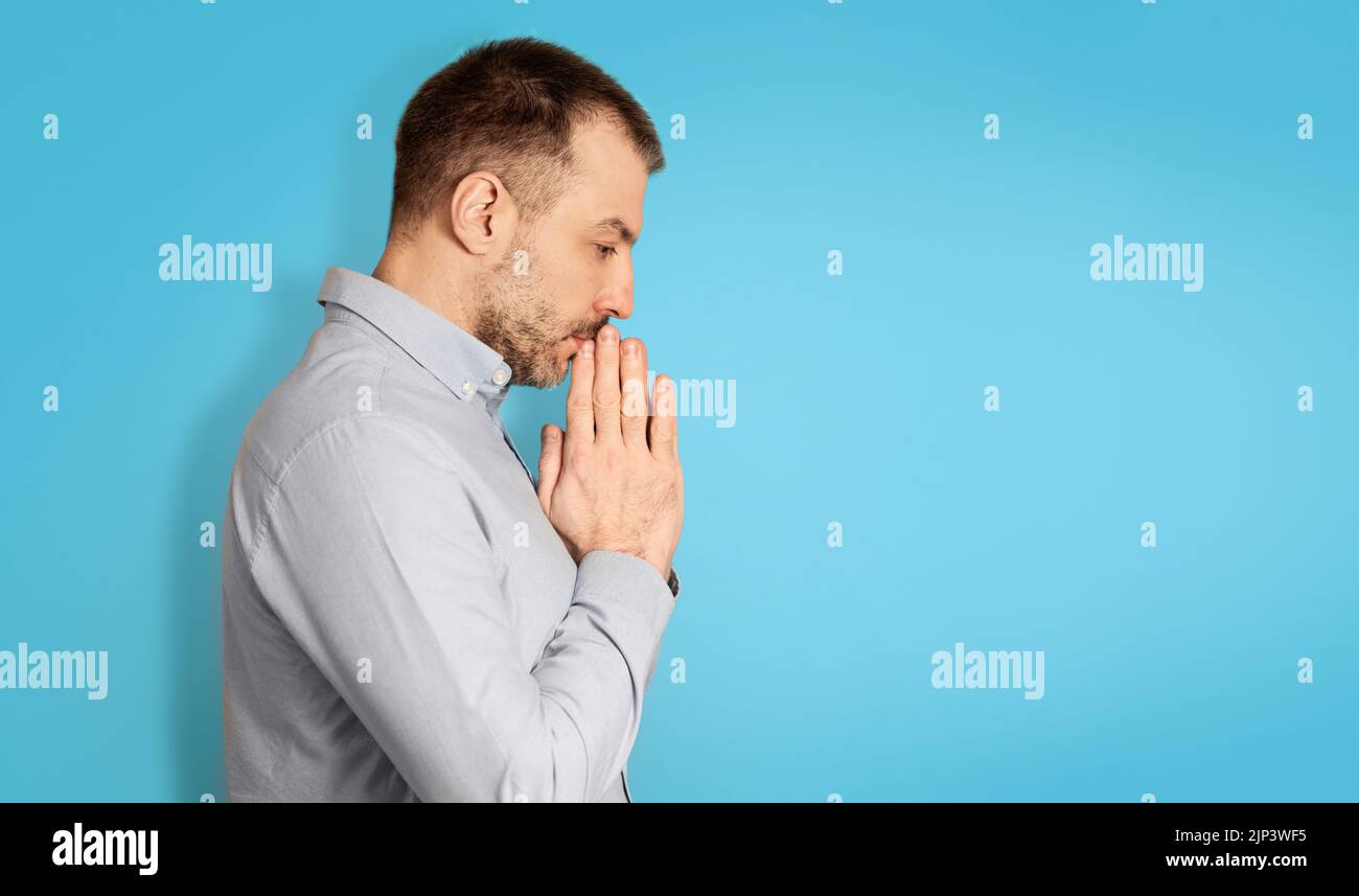 Unhappy Middle Aged Man Thinking Holding Hands Near Face, Studio Stock Photo
