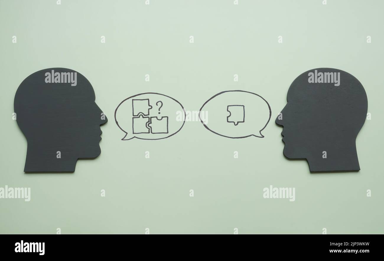 Heads and puzzles in speech bubbles. Leadership and problems solving concept. Stock Photo