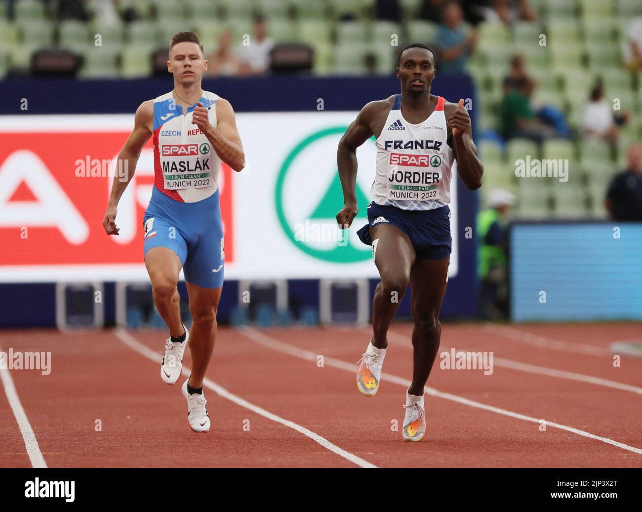 Athletics - 2022 European Championships - Olympiastadion, Munich, Germany - August 15, 2022 France's Tomas Jordier in action with Czech Republic's Pavel Maslak before winning the Men's 400m Round 1 Heat 4 REUTERS/Wolfgang Rattay Stock Photo