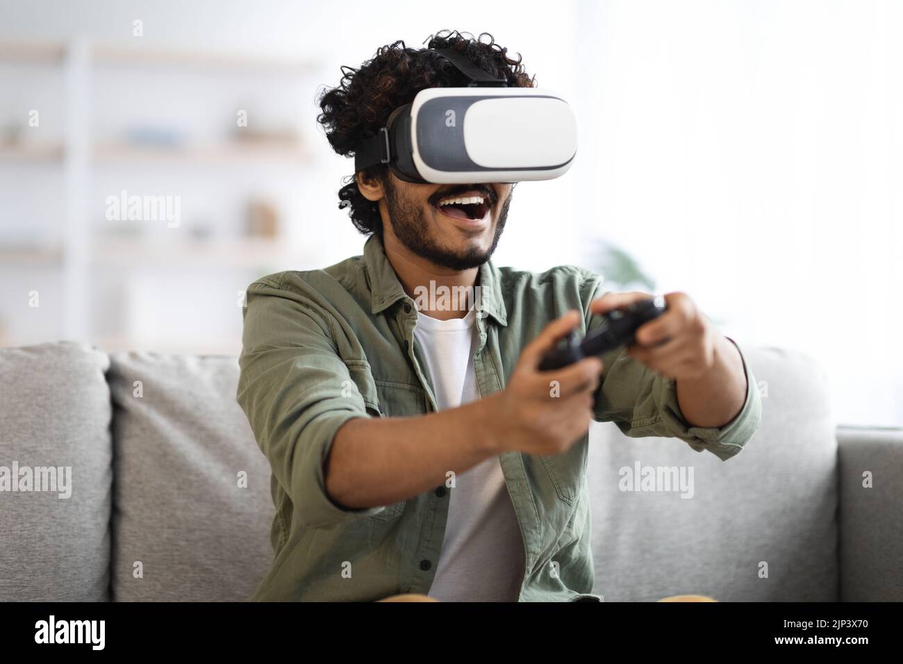 Young man trying virtual reality, playing video games Stock Photo