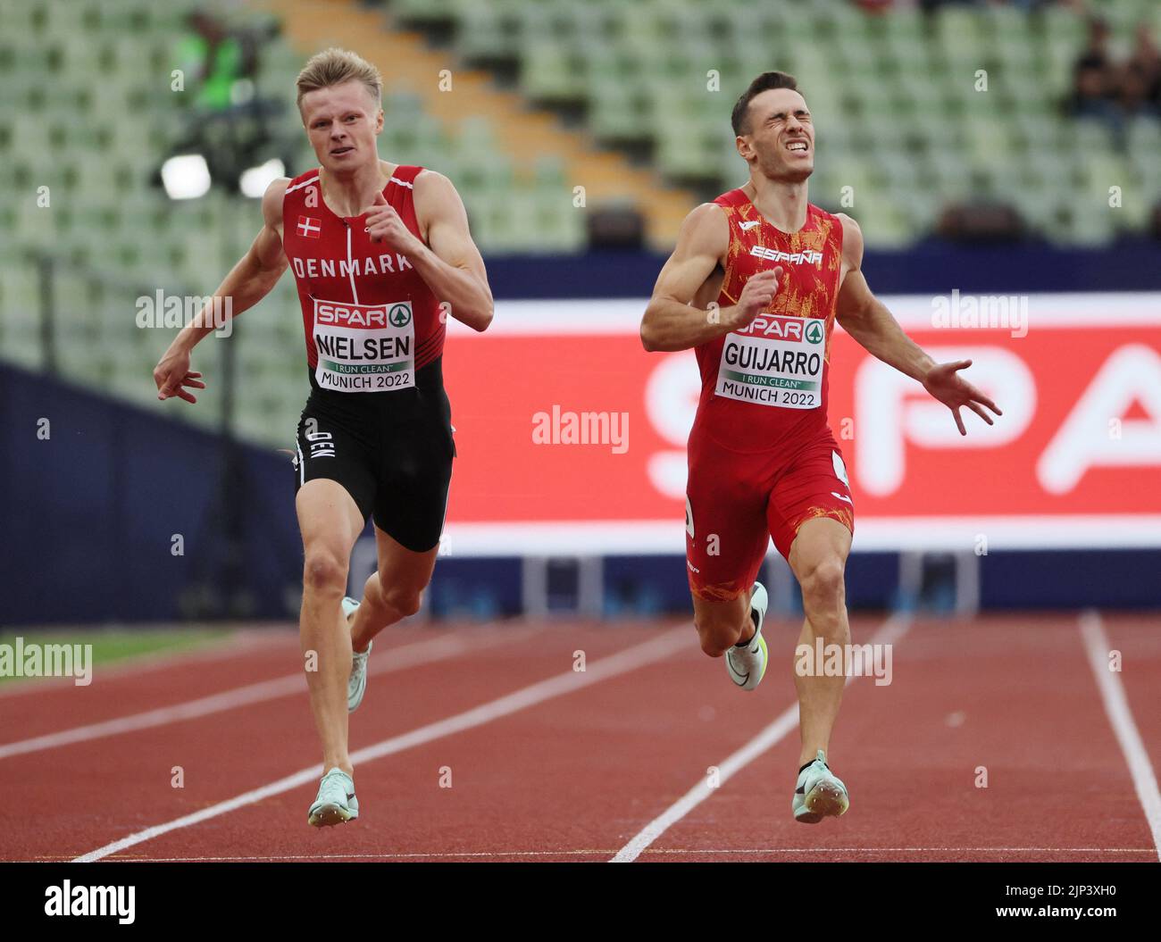 Athletics - 2022 European Championships - Olympiastadion, Munich, Germany - August 15, 2022 Denamrk's Gustav Lundholm Nielsen and Spain's Manuel Guijarro in action during the Men's 400m Round 1 Heat 4 REUTERS/Wolfgang Rattay Stock Photo
