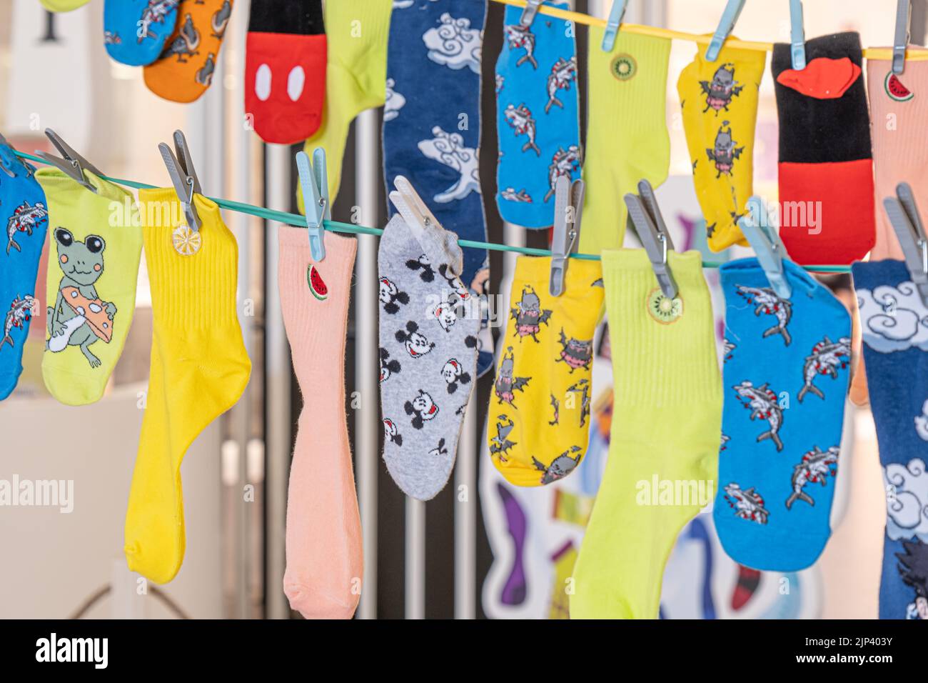 Different Multicolored Socks hanging on the rope Stock Photo - Alamy