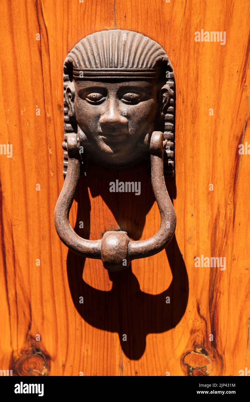 Egyptian Style Doorknob On A Wooden Door Seen In Siena Stock Photo